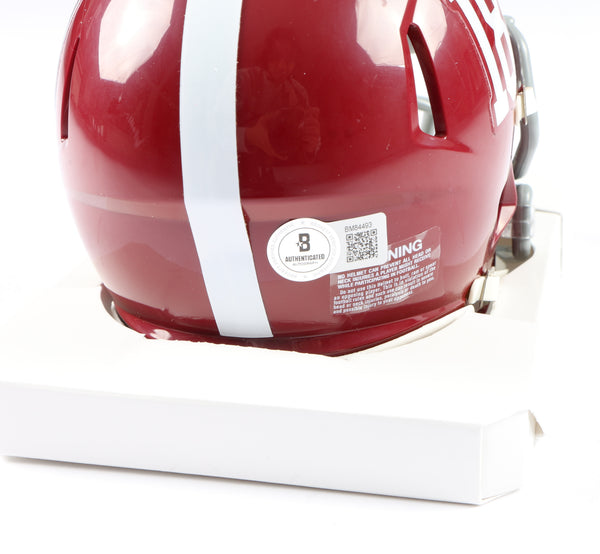 Coach Nick Saban signing some of your Alabama logo footballs. The